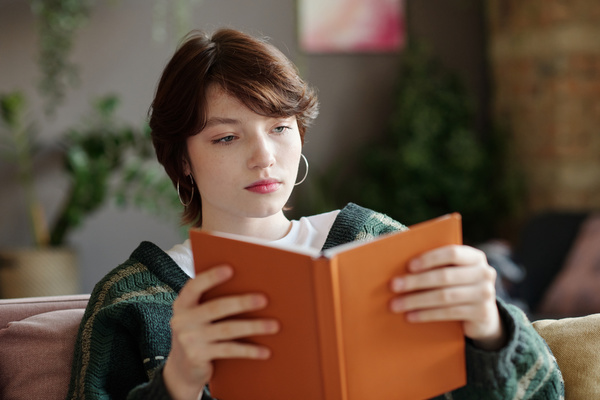 Girl in Green Cardigan Reads Book